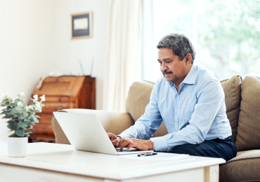 Man using laptop in home living room